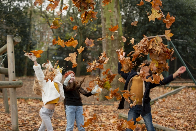 Medium shot kids playing with leaves min